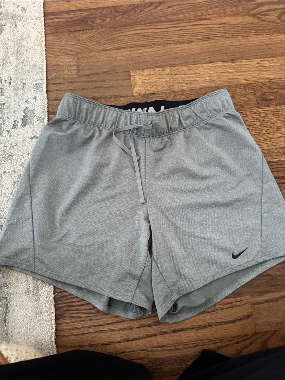 Nike Women's Light Gray Athletic Shorts with Black Swoosh